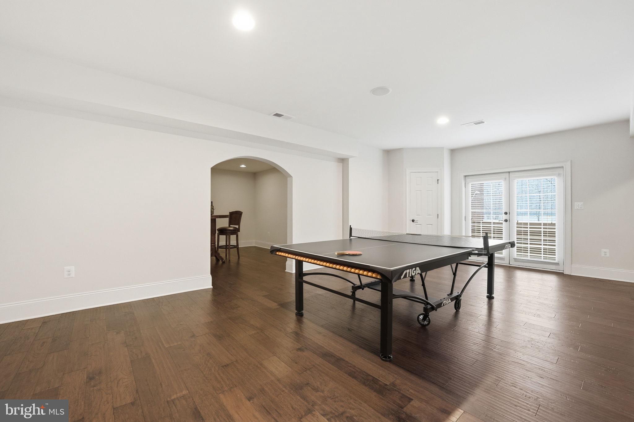 17972 Running Colt Place Leesburg, VA 20175 - Photo 76 of 99 a living room with furniture pool table wooden floor and a window