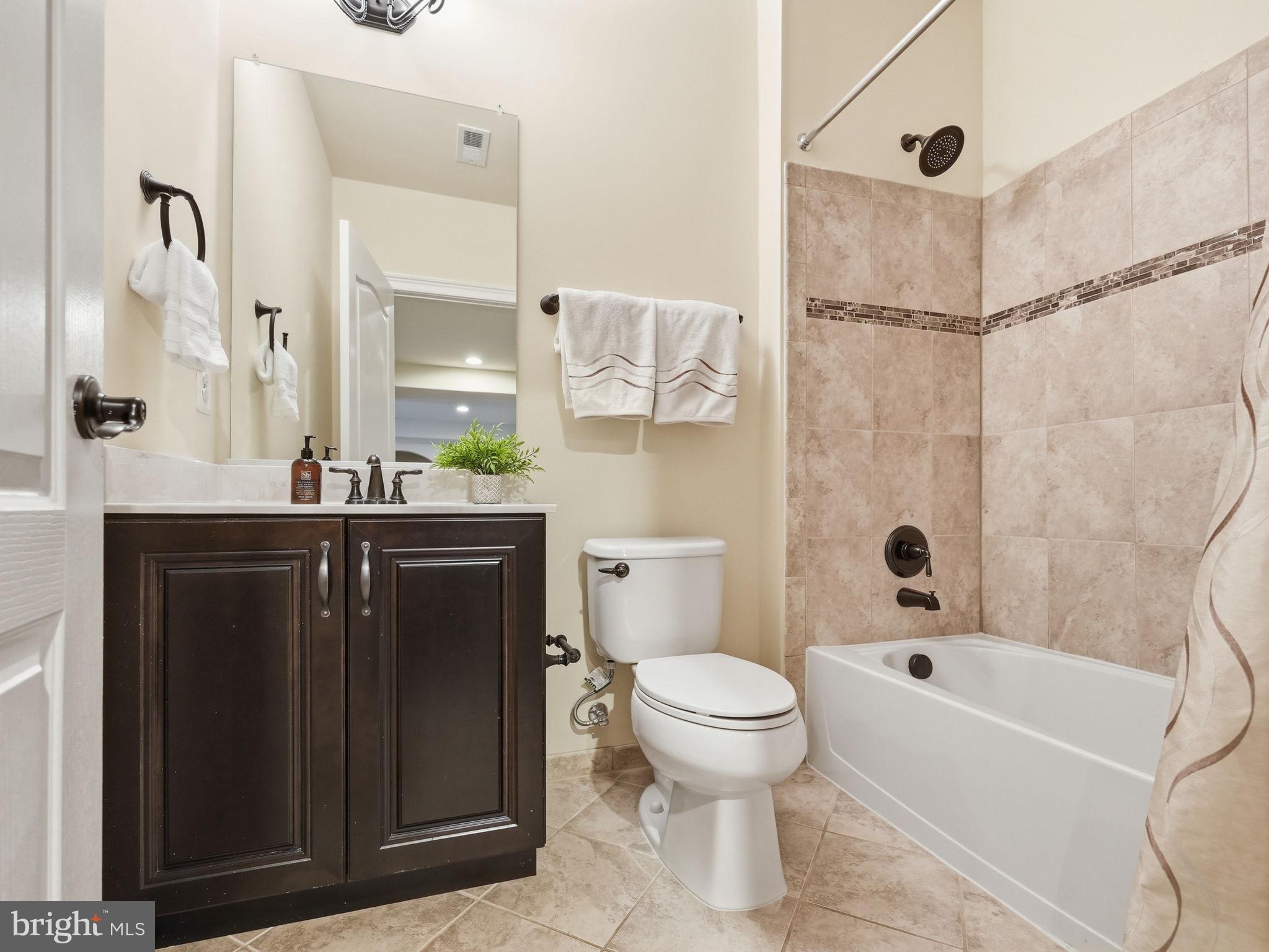 17972 Running Colt Place Leesburg, VA 20175 - Photo 80 of 99 a bathroom with a bathtub shower sink vanity and toilet