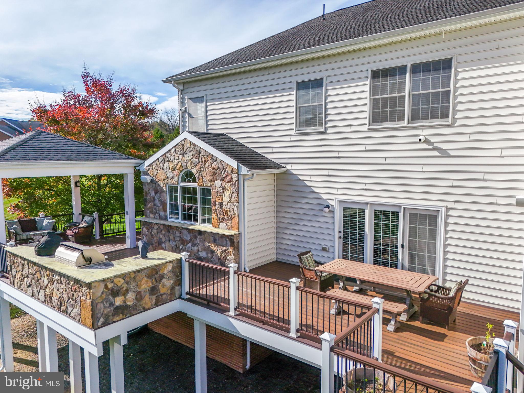 17972 Running Colt Place Leesburg, VA 20175 - Photo 83 of 99 a view of house with a chairs and table in a patio