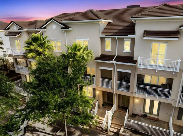 a large kitchen with kitchen island a sink a counter top space and living room view