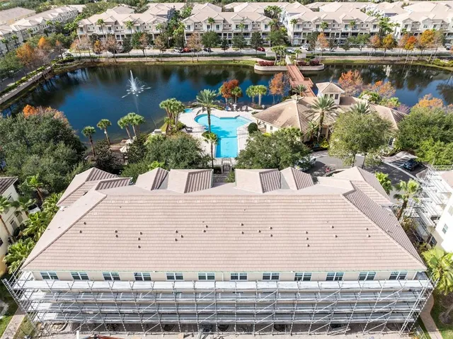 an aerial view of a house with a lake view