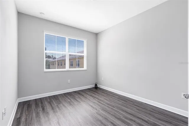 a bathroom with a granite countertop sink a toilet a mirror and shower