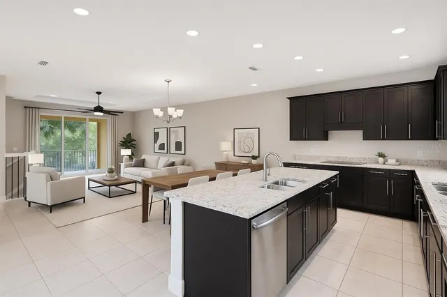 a large kitchen with kitchen island a sink a counter top space and living room view