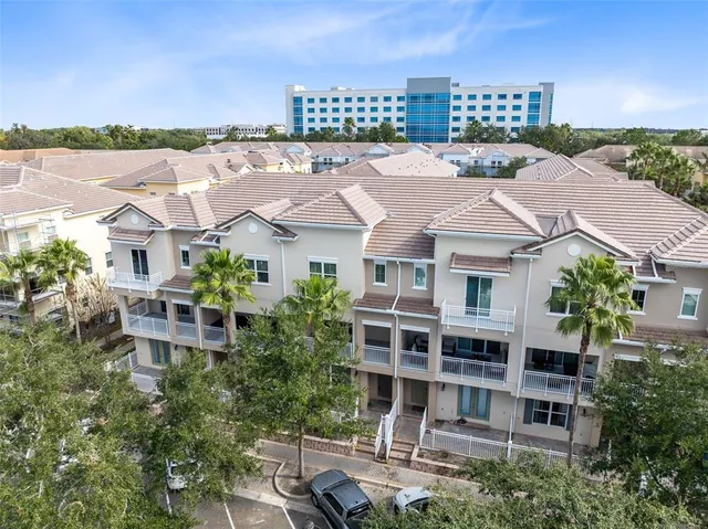 an aerial view of a house with swimming pool and outdoor seating