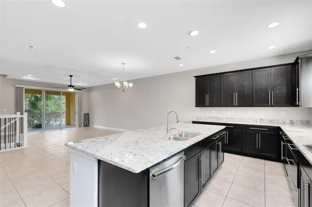 a kitchen with a sink and a stove top oven with wooden floor
