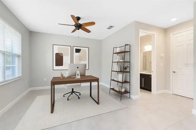 an empty room with closet and windows