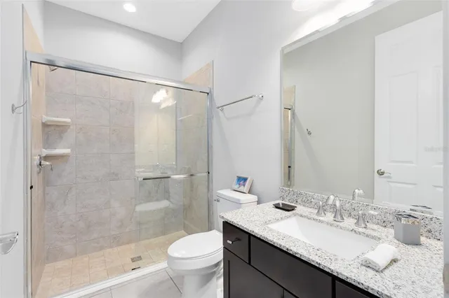 a view of an empty room with windows & cabinet