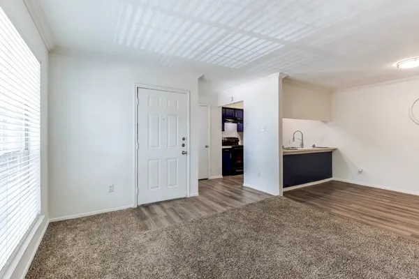 an empty room with a cabinet and mirrors