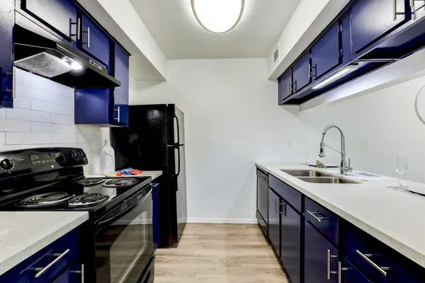a view of a kitchen with wooden floor and sink