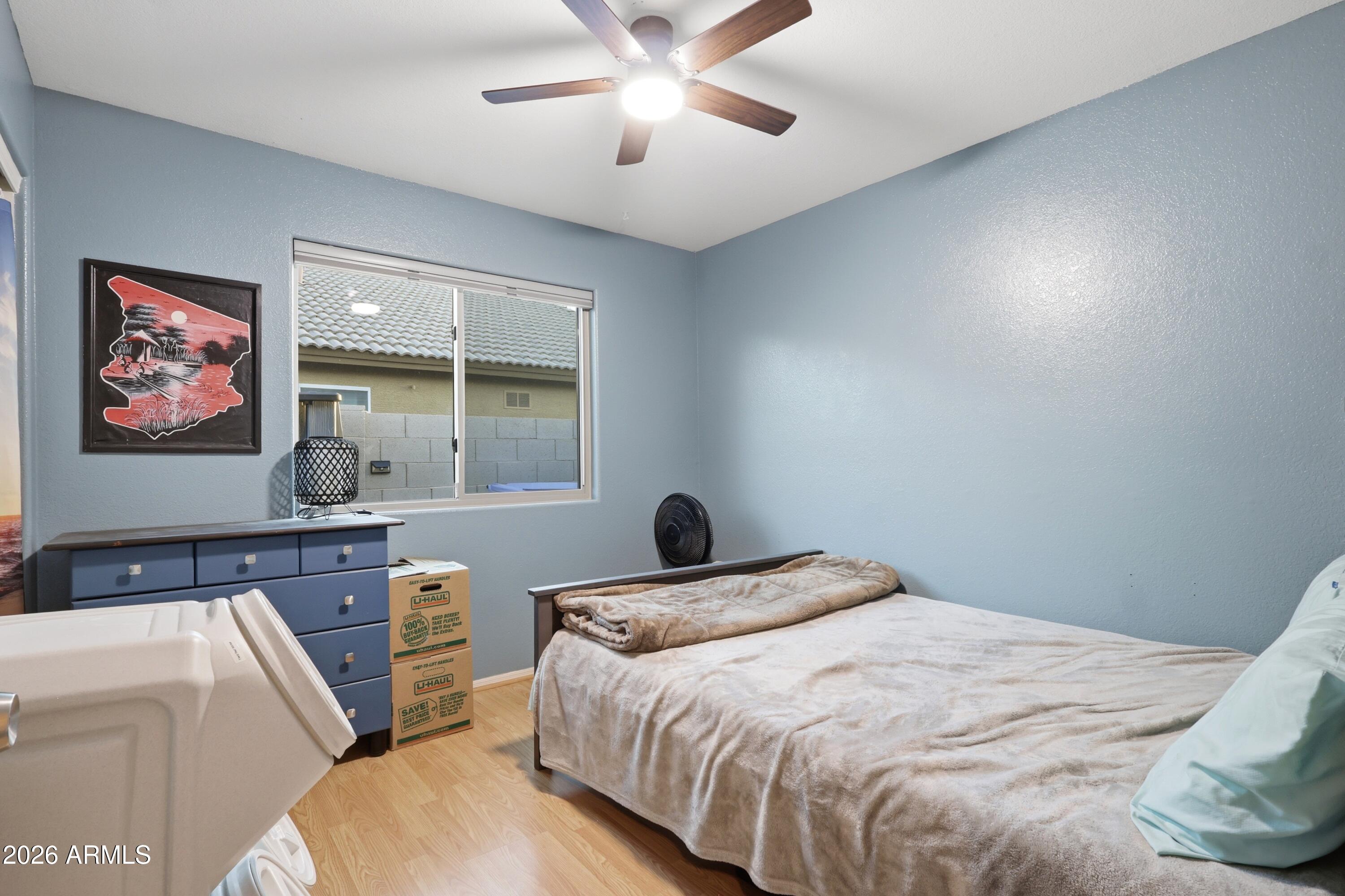 661 North Joshua Tree Lane Gilbert, AZ 85234 - Photo 17 of 47 a bedroom with a bed and a large window