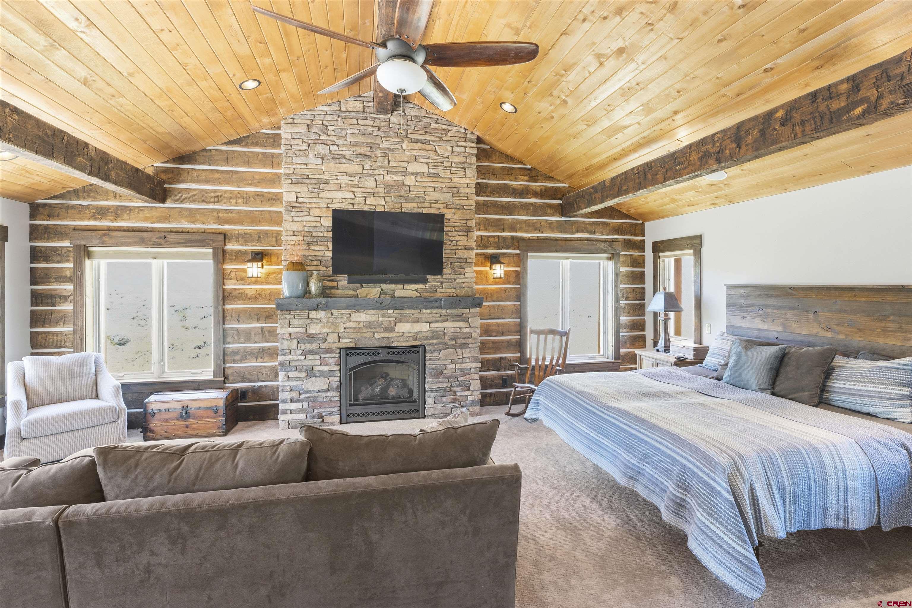 684 Falcon Way Montrose, CO 81403 - Photo 13 of 43 a spacious bedroom with a balcony a bed and a flat screen tv