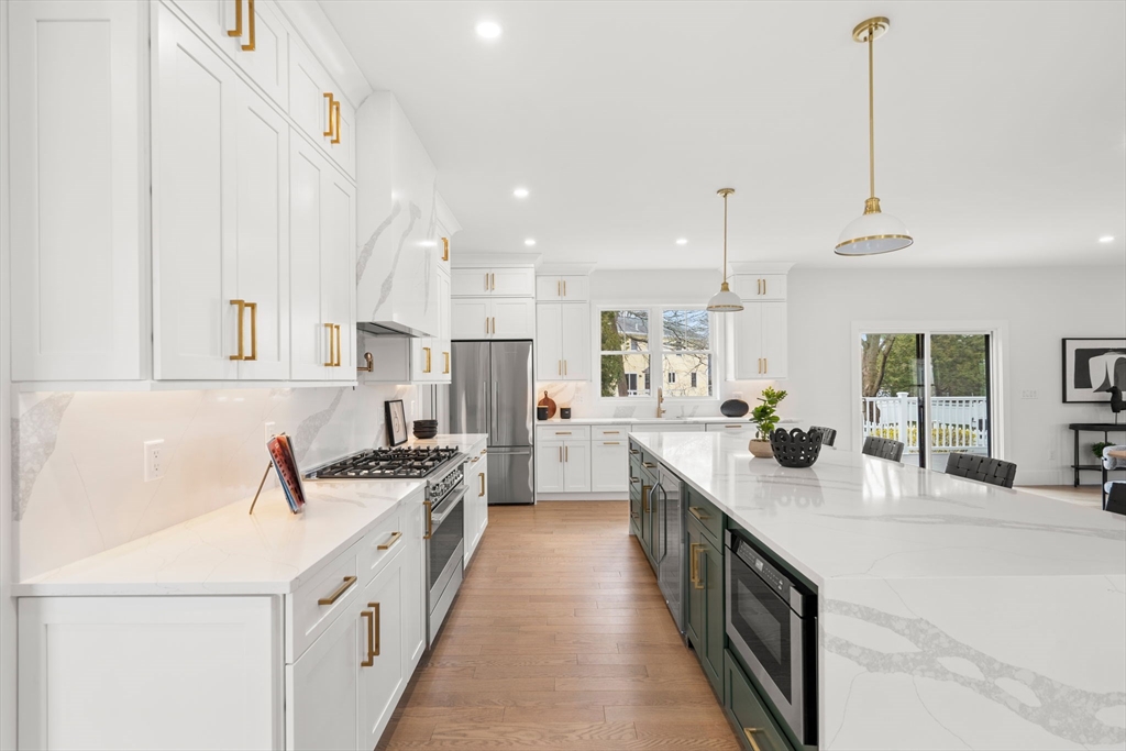 25 Sachem Road Needham, MA 02494 - Photo 11 of 40 a kitchen with counter top space a sink a stove and refrigerator
