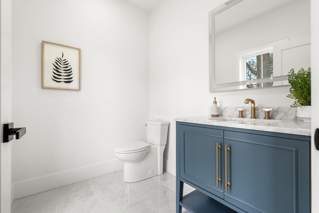 25 Sachem Road Needham, MA 02494 - Photo 14 of 40 a bathroom with a toilet sink and mirror