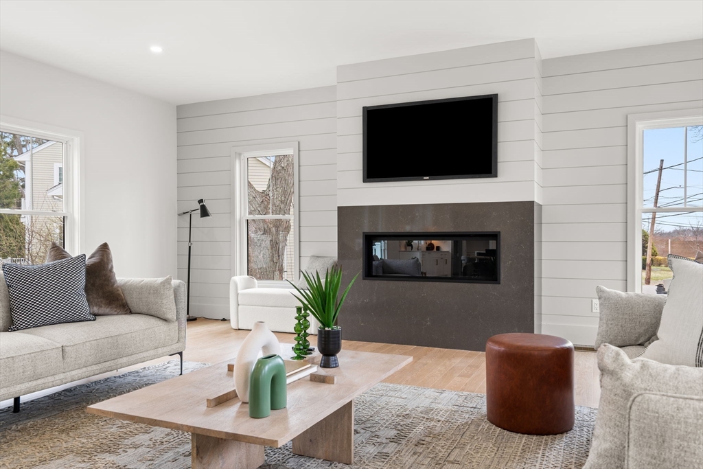 25 Sachem Road Needham, MA 02494 - Photo 23 of 40 a living room with furniture a flat screen tv and a fireplace