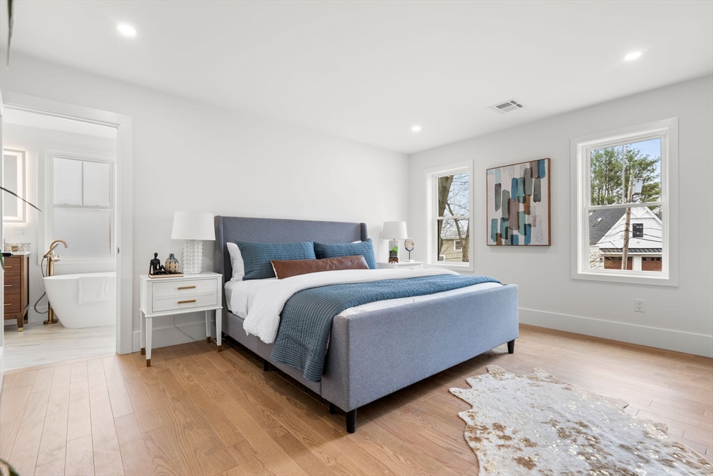 25 Sachem Road Needham, MA 02494 - Photo 26 of 40 a spacious bedroom with a bed and a large window