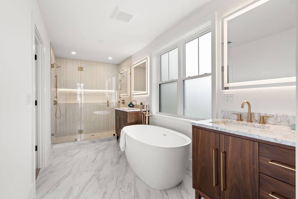 25 Sachem Road Needham, MA 02494 - Photo 28 of 40 a bathroom with a granite countertop sink mirror bathtub and toilet