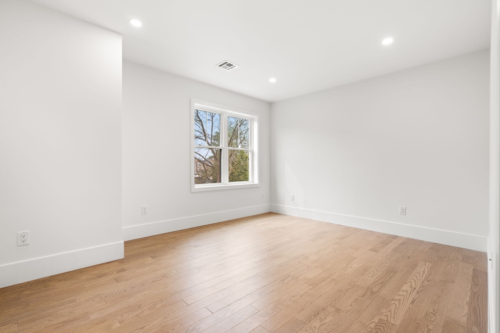 25 Sachem Road Needham, MA 02494 - Photo 31 of 40 an empty room with wooden floor and windows