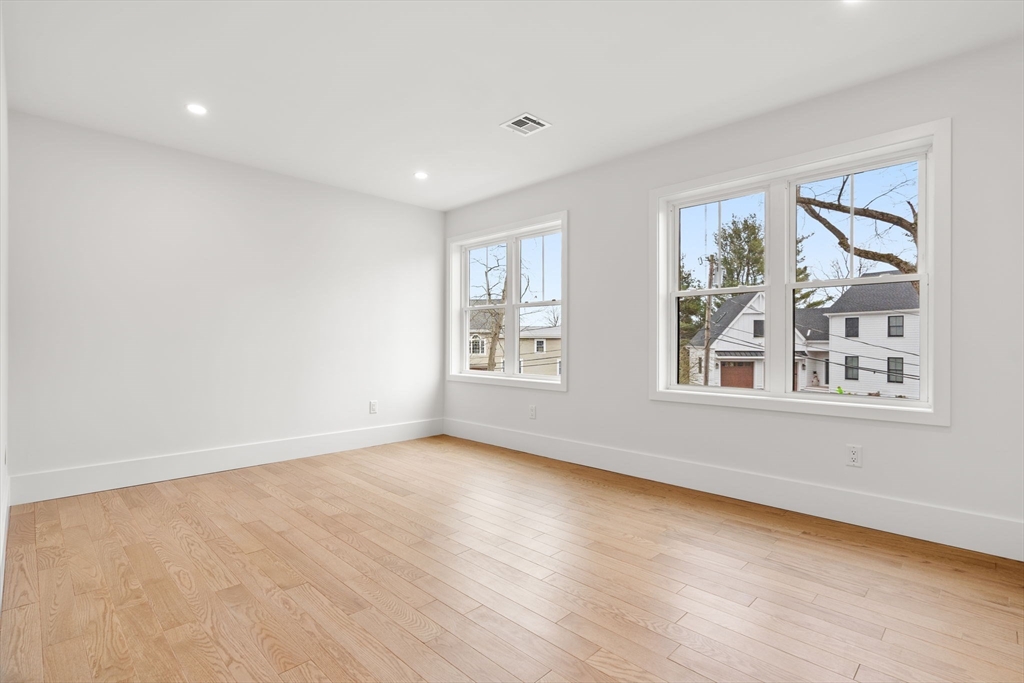 25 Sachem Road Needham, MA 02494 - Photo 32 of 40 a view of an empty room with a window and wooden floor