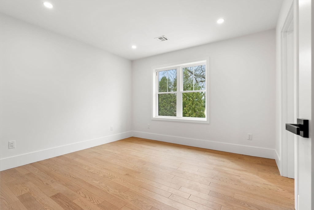 25 Sachem Road Needham, MA 02494 - Photo 36 of 40 an empty room with wooden floor and window