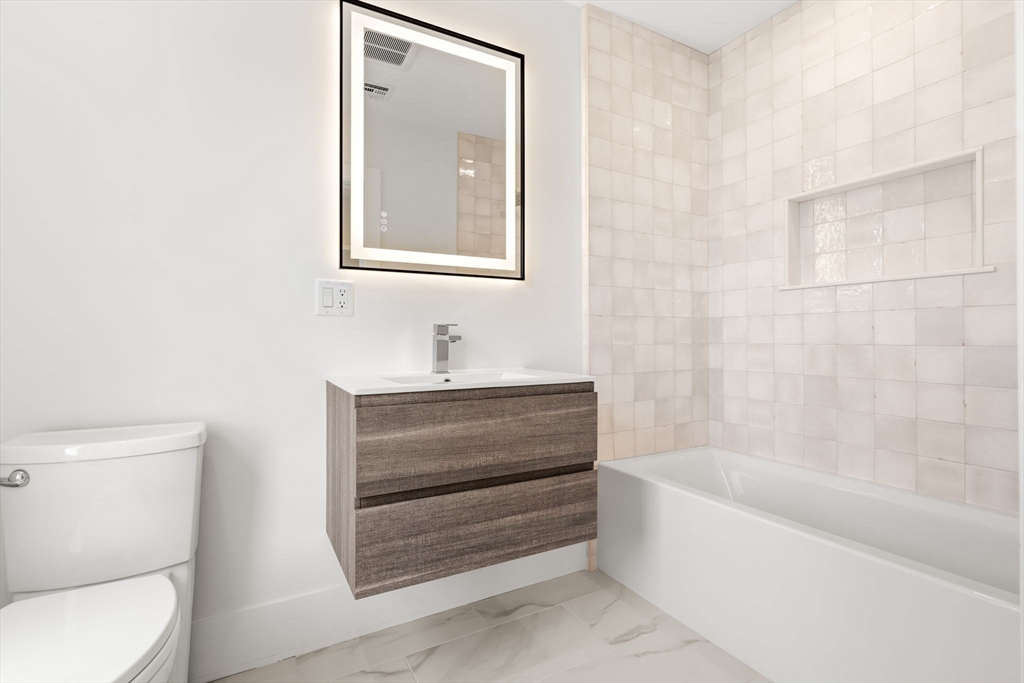 25 Sachem Road Needham, MA 02494 - Photo 38 of 40 a bathroom with a bathtub and a toilet