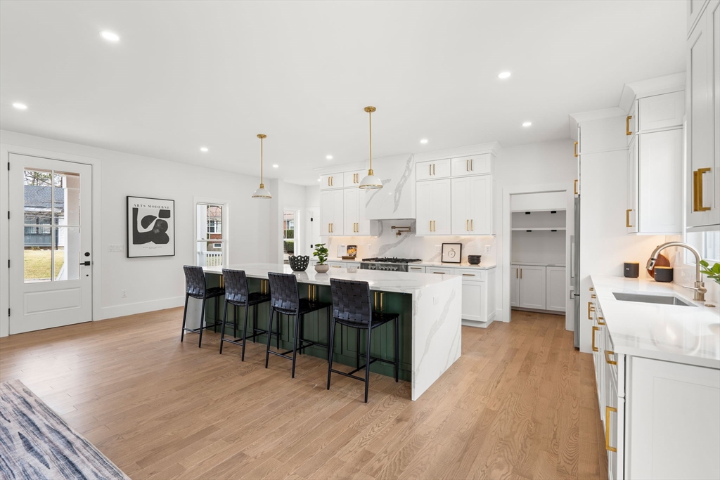 25 Sachem Road Needham, MA 02494 - Photo 5 of 40 a kitchen with white cabinets and stainless steel appliances