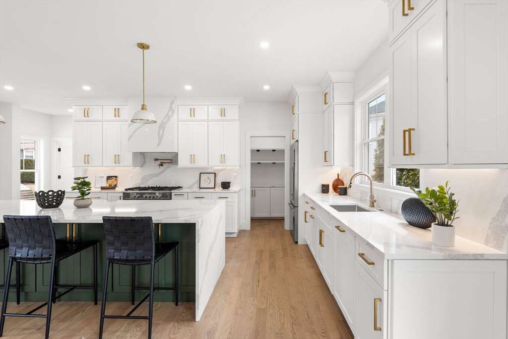 25 Sachem Road Needham, MA 02494 - Photo 8 of 40 a kitchen with white cabinets stove and white appliances