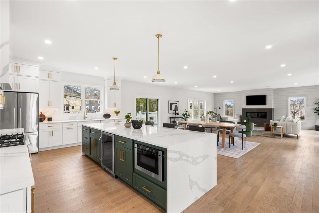 25 Sachem Road Needham, MA 02494 - Photo 10 of 40 a large kitchen with stainless steel appliances kitchen island granite countertop a large island in the center