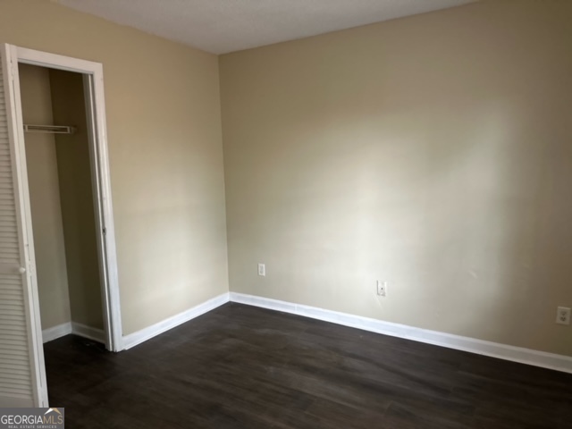 323 Carriage Lane, Unit B Albany, GA 31721 - Photo 20 of 23 an empty room with wooden floor and closet