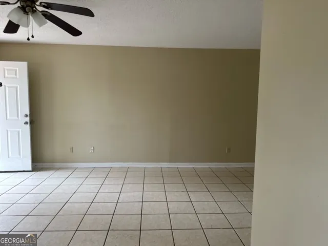 a kitchen with a refrigerator a stove top oven and cabinets