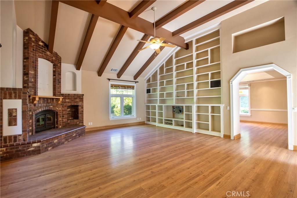 46341 El Prado Road Temecula, CA 92590 - Photo 13 of 52 a view of empty room with wooden floor and fireplace