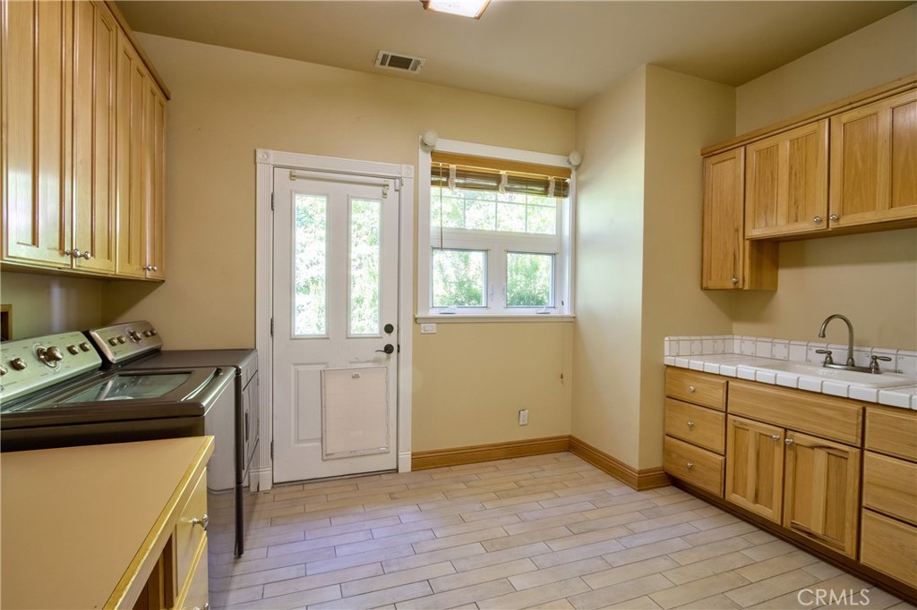 46341 El Prado Road Temecula, CA 92590 - Photo 16 of 52 a kitchen with a sink and wooden cabinets