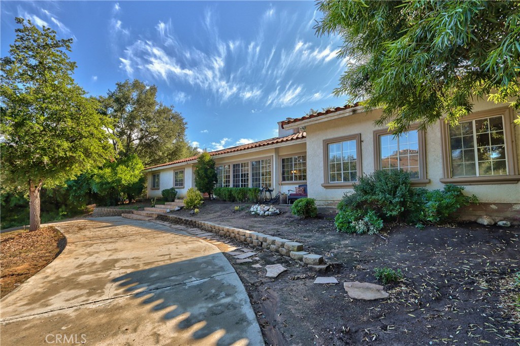 46341 El Prado Road Temecula, CA 92590 - Photo 28 of 52 a front view of a house with yard and trees