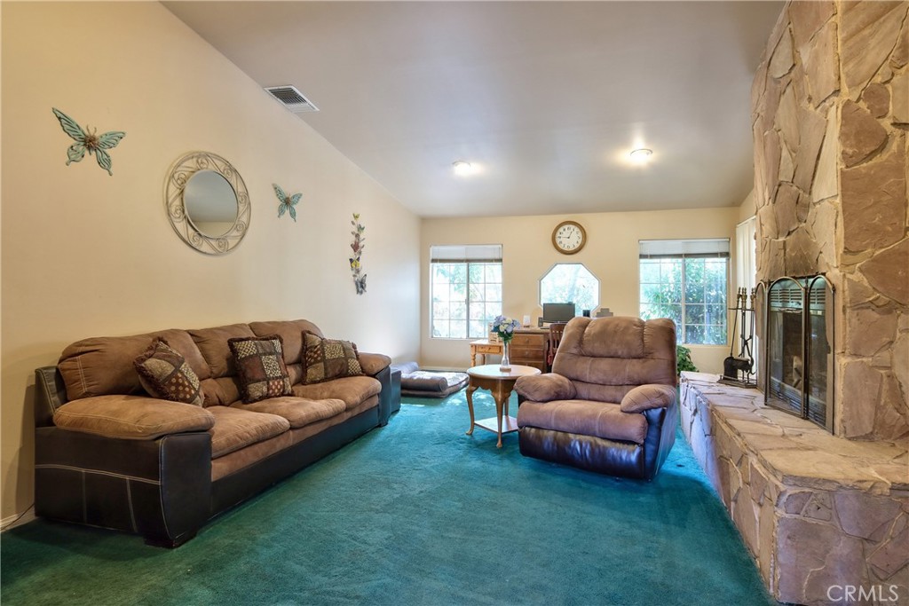 46341 El Prado Road Temecula, CA 92590 - Photo 31 of 52 a living room with furniture and a chandelier