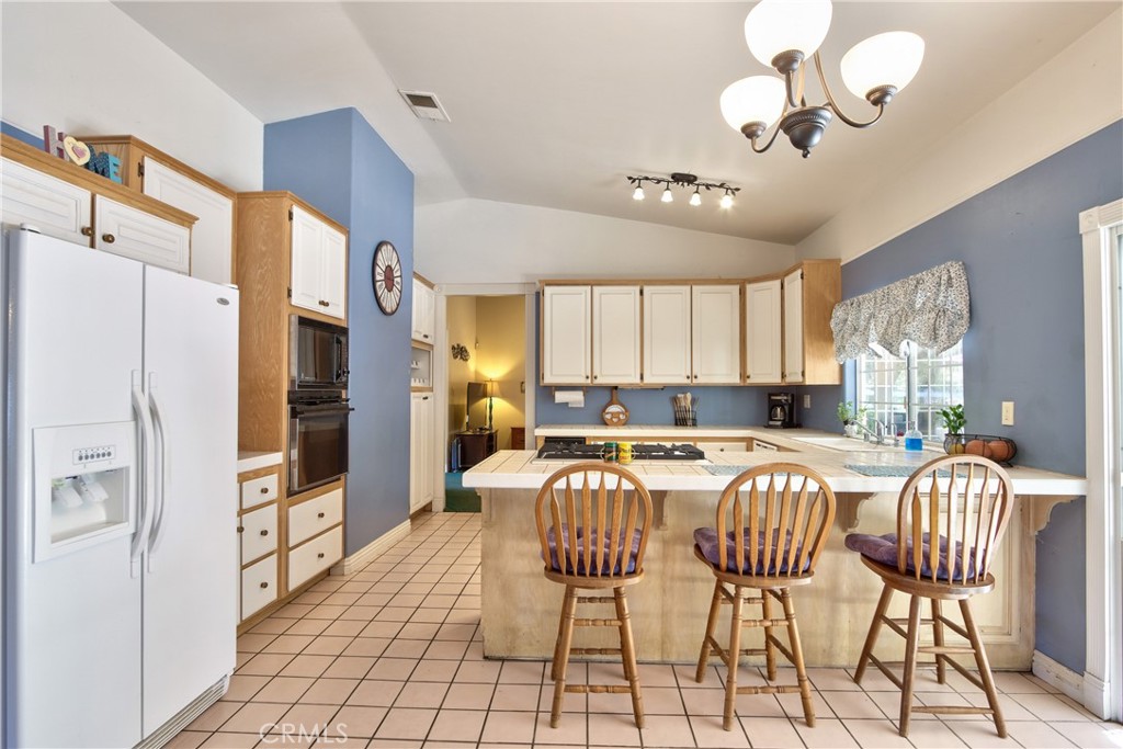 46341 El Prado Road Temecula, CA 92590 - Photo 33 of 52 a view of a dining room with furniture a chandelier and wooden floor