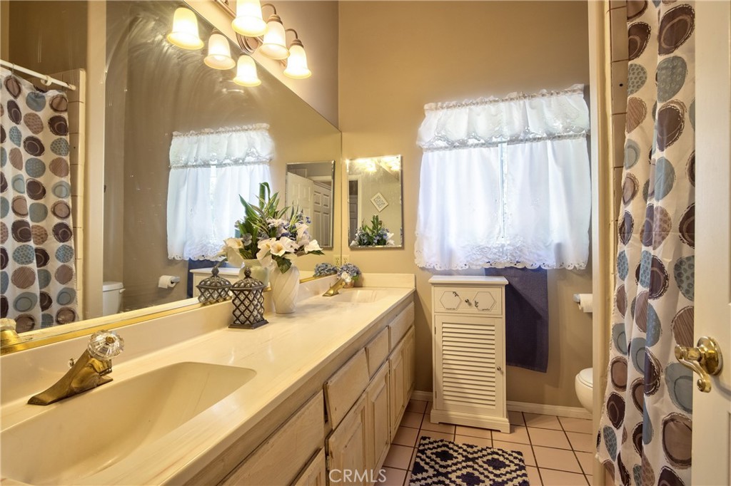 46341 El Prado Road Temecula, CA 92590 - Photo 37 of 52 a bathroom with a sink and a mirror