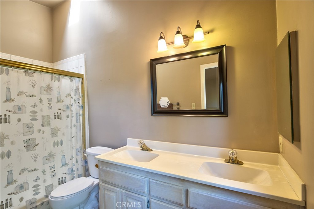 46341 El Prado Road Temecula, CA 92590 - Photo 39 of 52 a bathroom with a sink vanity mirror and toilet