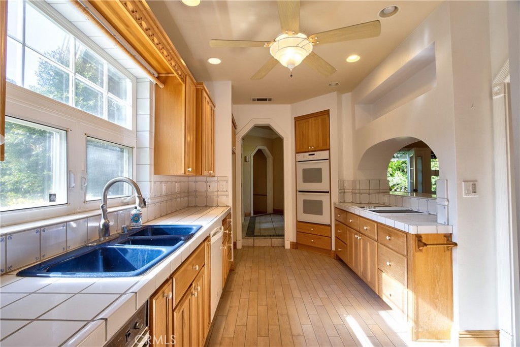 46341 El Prado Road Temecula, CA 92590 - Photo 8 of 52 a kitchen with sink a counter space and stainless steel appliances