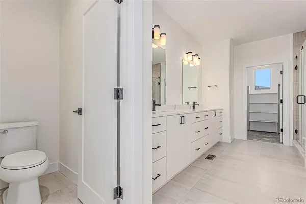 a bathroom with double vanity sink and mirror