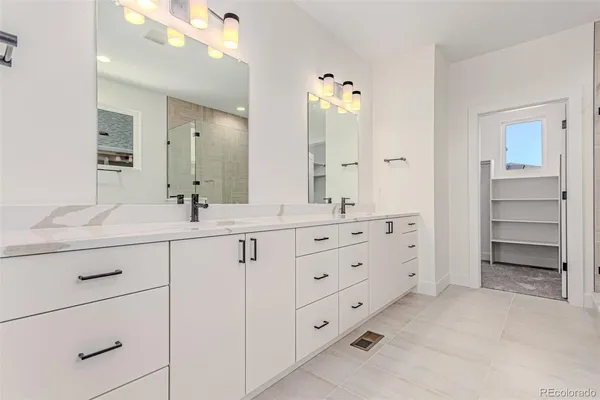 a bathroom with double sink and a mirror