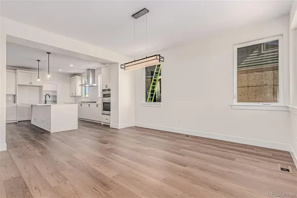 a kitchen with kitchen island white cabinets and refrigerator