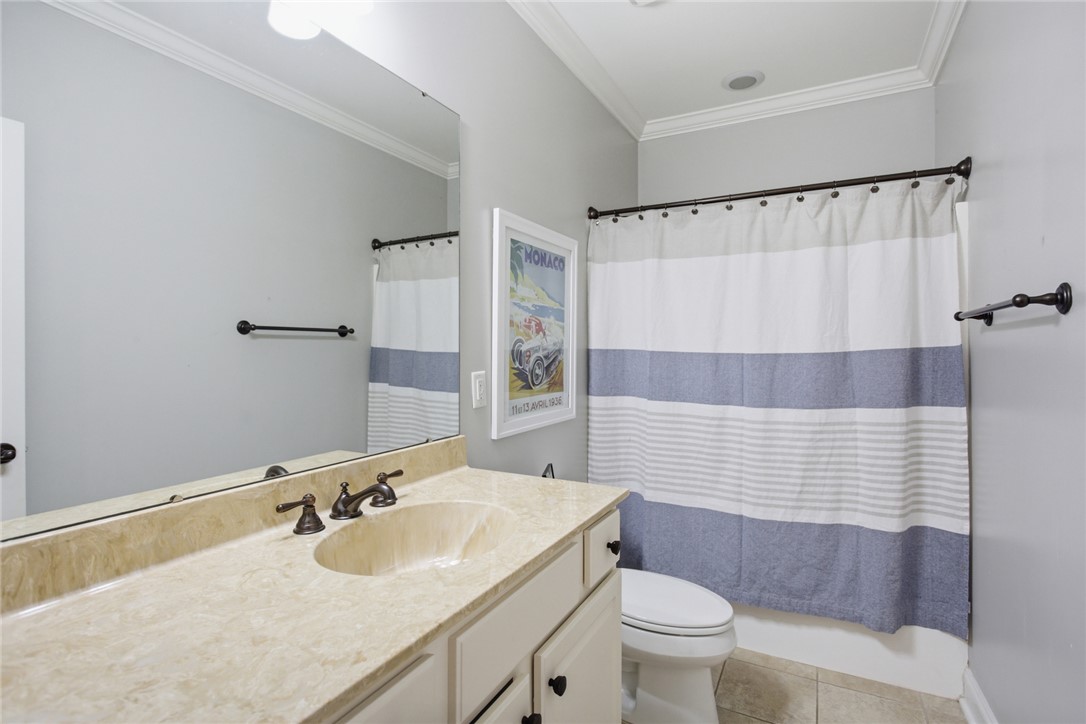 578 Sunset Point Drive West Union, SC 29696 - Photo 27 of 46 This bathroom features a sophisticated vanity with ample counter space and a classic shower curtain.