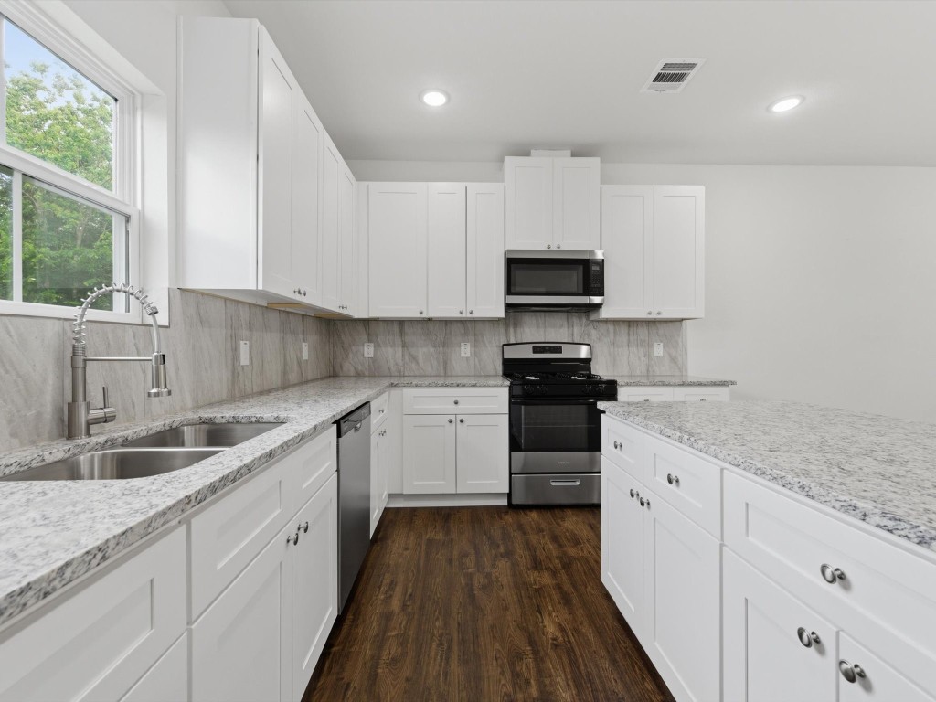 2803 Topiary Lane Houston, TX 77014 - Photo 14 of 30 Granite counters, a large center island, self-close cabinets, and abundant storage set the stage for daily culinary adventures.
