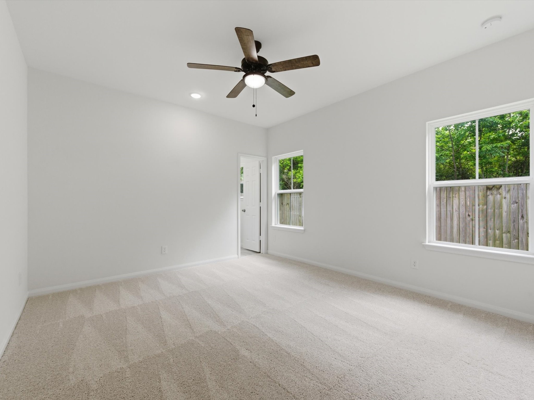 2803 Topiary Lane Houston, TX 77014 - Photo 17 of 30 The main-level primary bedroom provides a quiet escape, thoughtfully positioned for both comfort and convenience.