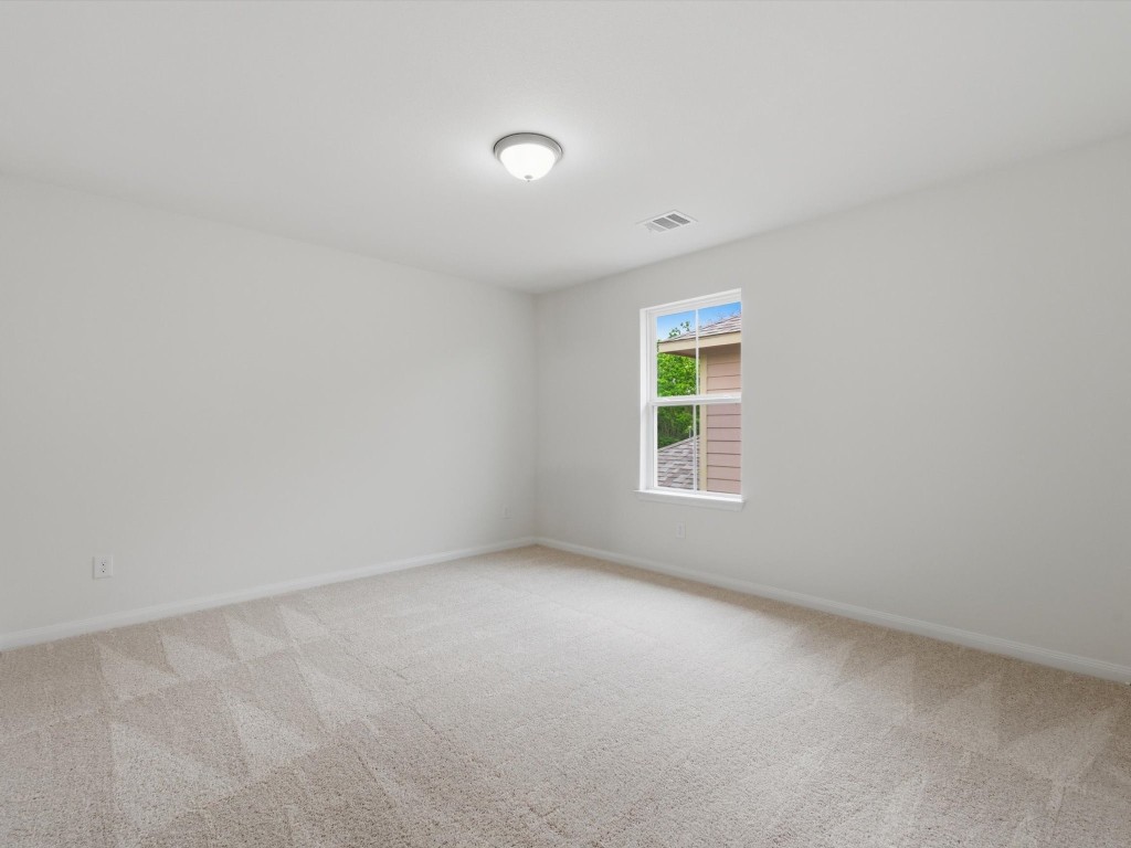 2803 Topiary Lane Houston, TX 77014 - Photo 22 of 30 Well-proportioned secondary bedrooms create comfortable spaces that easily adapt to guests, family, or work-from-home living.