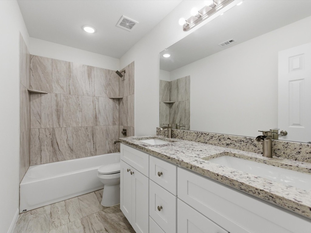 2803 Topiary Lane Houston, TX 77014 - Photo 23 of 30 The secondary bathroom is designed with sleek finishes, granite counters, and dual sinks creating elevated everyday living.