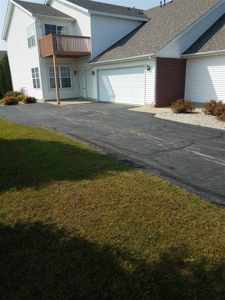 10138 Monarch Road, Unit 1 Roscoe, IL 61073 - Photo 1 of 13 a view of a house with a yard and garage