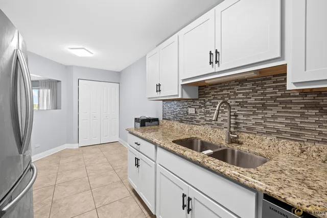 a kitchen with granite countertop a sink and a stove