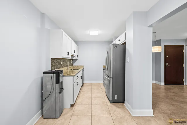 a kitchen with stainless steel appliances granite countertop a refrigerator and a stove