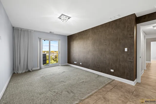 an empty room with yard and natural light