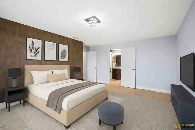 a spacious bedroom with a bed and a flat screen television